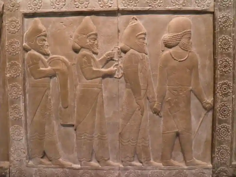 Traveling people, one holding a double headed animal bracelet Traveling people, one holding a double headed animal bracelet